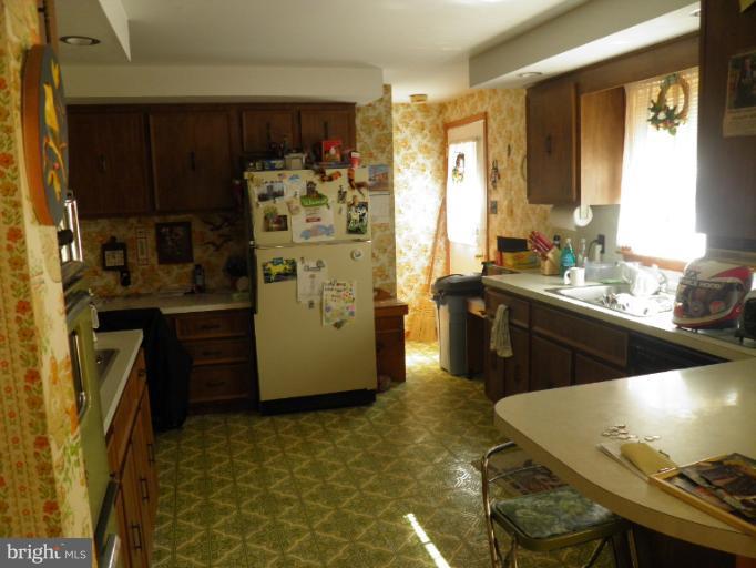 166 Bennett Berkeley Springs Berkeley Springs, WV 25411 - Photo 2 of 27 a kitchen with a sink stove and refrigerator
