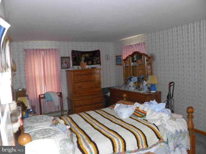 166 Bennett Berkeley Springs Berkeley Springs, WV 25411 - Photo 11 of 27 a bedroom with a bed and wooden floor