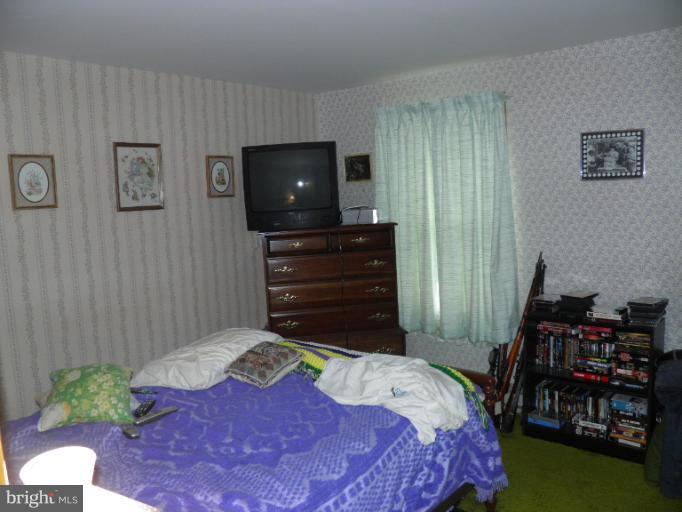 166 Bennett Berkeley Springs Berkeley Springs, WV 25411 - Photo 14 of 27 a bedroom with a bed and a flat screen tv