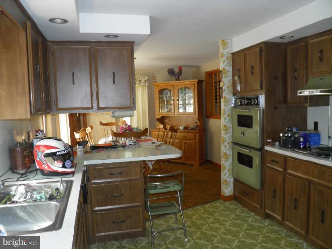 166 Bennett Berkeley Springs Berkeley Springs, WV 25411 - Photo 3 of 27 a kitchen with stainless steel appliances granite countertop a refrigerator stove and sink