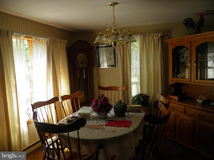 166 Bennett Berkeley Springs Berkeley Springs, WV 25411 - Photo 4 of 27 a view of a dining room with furniture window and wooden floor