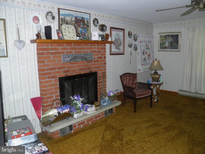 166 Bennett Berkeley Springs Berkeley Springs, WV 25411 - Photo 5 of 27 a living room with furniture and a fireplace