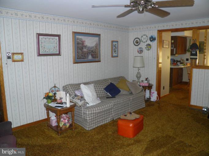 166 Bennett Berkeley Springs Berkeley Springs, WV 25411 - Photo 6 of 27 a living room with furniture rug and window