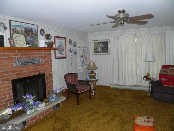 166 Bennett Berkeley Springs Berkeley Springs, WV 25411 - Photo 8 of 27 a living room with furniture and a fireplace