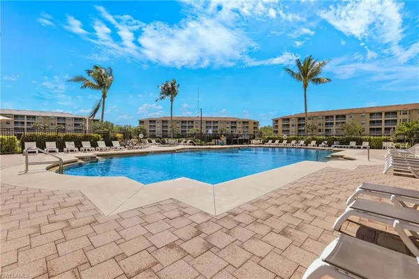 a view of a swimming pool and a lounge chair