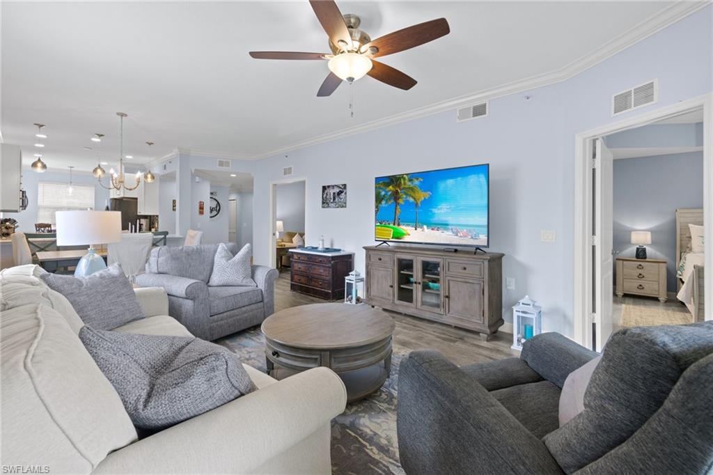 8550 Kingbird Loop, Unit 620 Estero, FL 33967 - Photo 11 of 30 a living room with furniture a fireplace and a flat screen tv