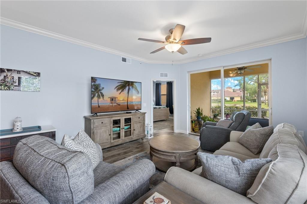 8550 Kingbird Loop, Unit 620 Estero, FL 33967 - Photo 13 of 30 a living room with furniture a flat screen tv and a large window