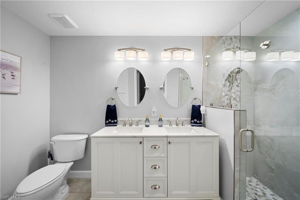 8550 Kingbird Loop, Unit 620 Estero, FL 33967 - Photo 15 of 30 a bathroom with a double vanity sink mirror and toilet