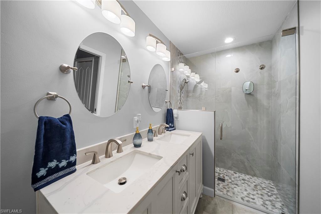 8550 Kingbird Loop, Unit 620 Estero, FL 33967 - Photo 16 of 30 a bathroom with a sink mirror and vanity