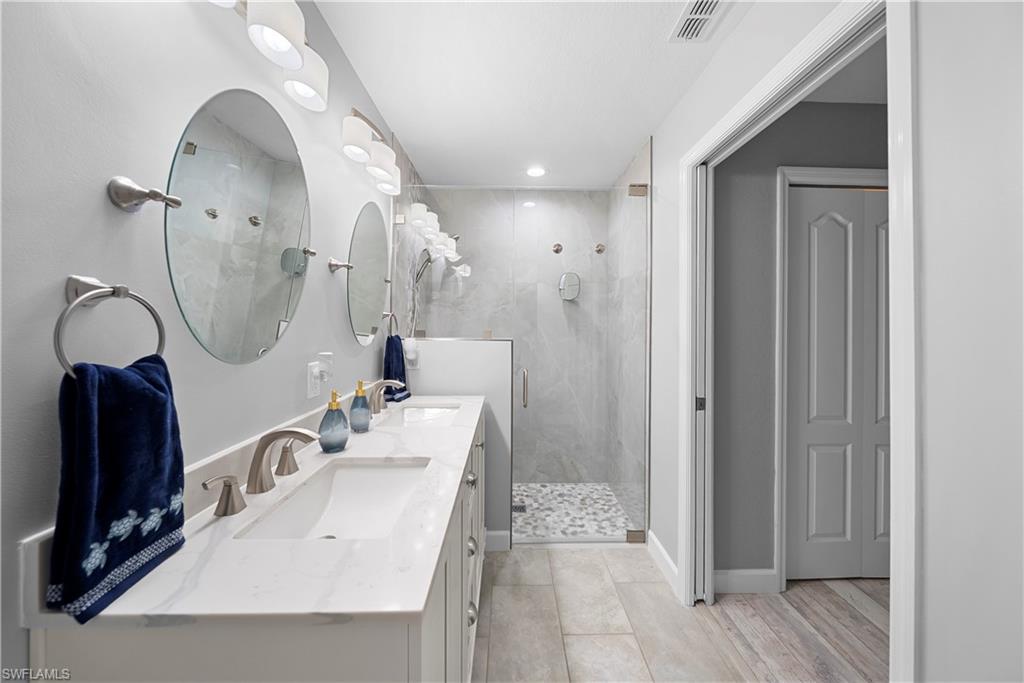 8550 Kingbird Loop, Unit 620 Estero, FL 33967 - Photo 17 of 30 a bathroom with a double vanity sink mirror and shower