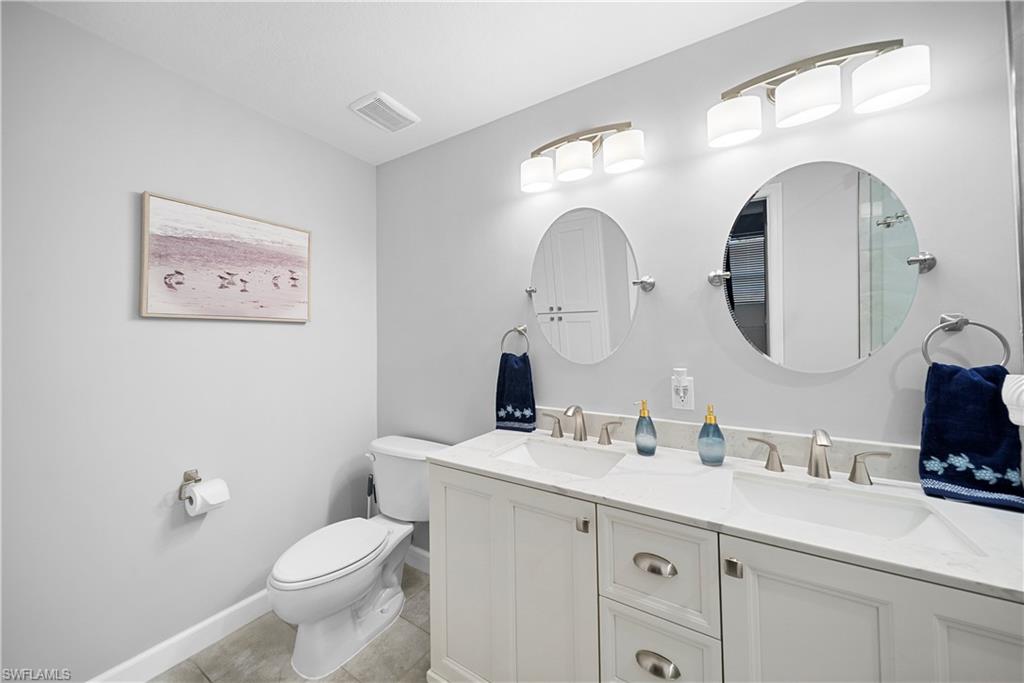 8550 Kingbird Loop, Unit 620 Estero, FL 33967 - Photo 18 of 30 a bathroom with a toilet a sink and a mirror