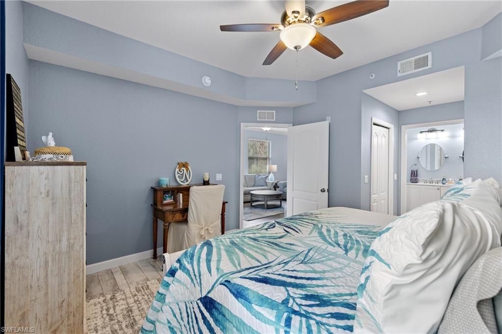 8550 Kingbird Loop, Unit 620 Estero, FL 33967 - Photo 19 of 30 a bedroom with a bed and a chandelier