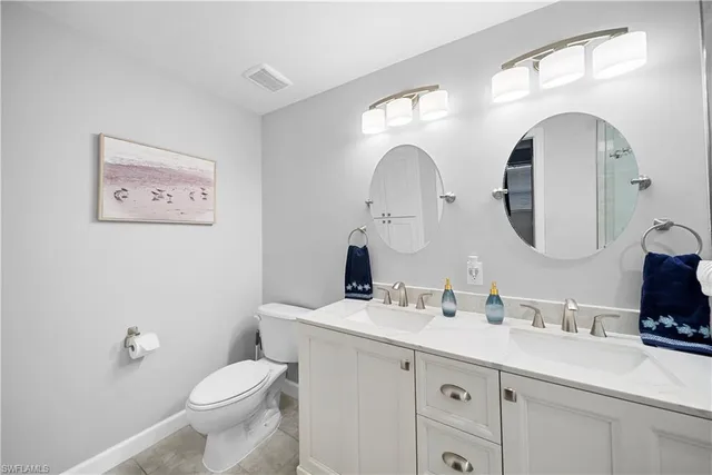 a bathroom with a toilet a sink and a mirror