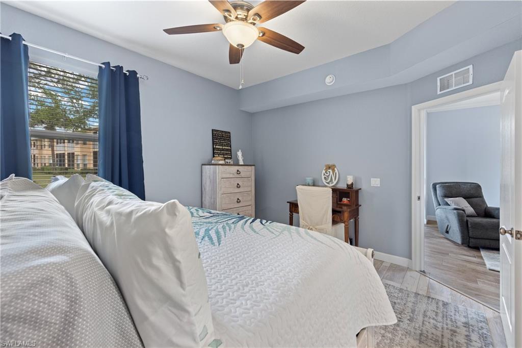 8550 Kingbird Loop, Unit 620 Estero, FL 33967 - Photo 20 of 30 a bedroom with a large bed and a chandelier