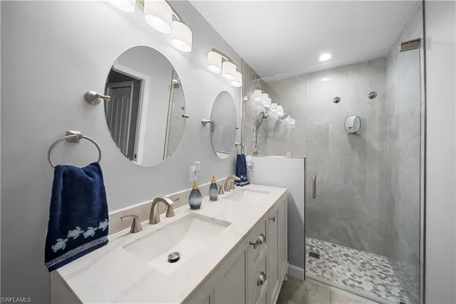 a bathroom with a sink mirror and vanity