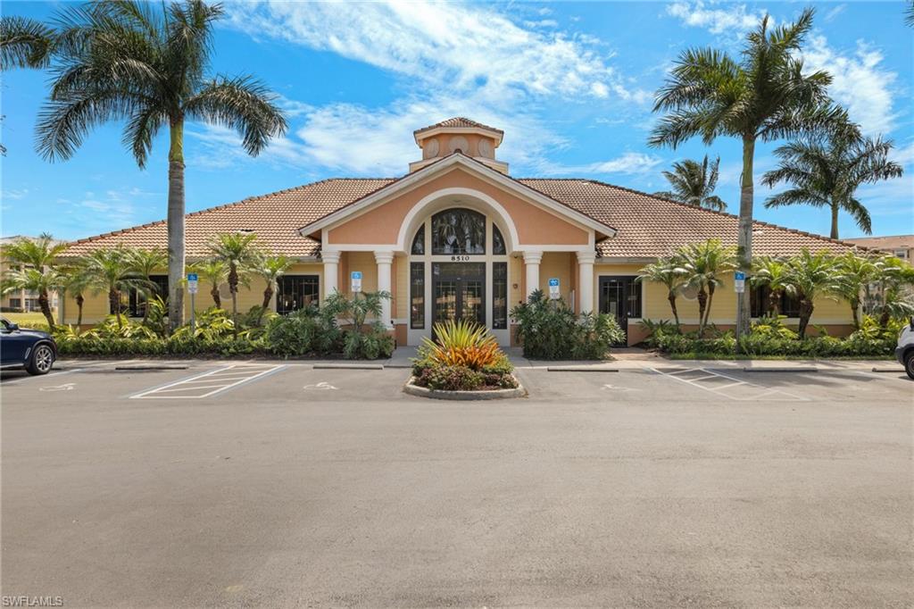 8550 Kingbird Loop, Unit 620 Estero, FL 33967 - Photo 2 of 30 front view of a house with a yard and palm trees