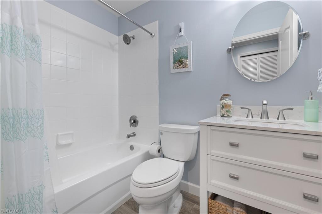 8550 Kingbird Loop, Unit 620 Estero, FL 33967 - Photo 21 of 30 a bathroom with a toilet a sink a mirror and vanity
