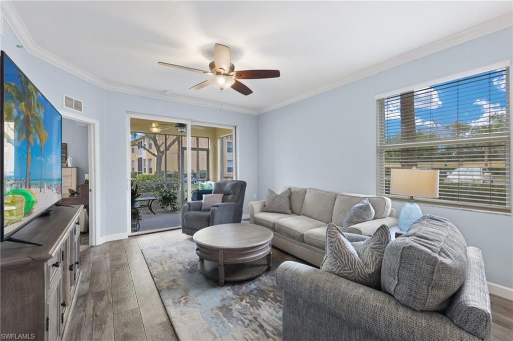 8550 Kingbird Loop, Unit 620 Estero, FL 33967 - Photo 10 of 30 a living room with furniture and a floor to ceiling window