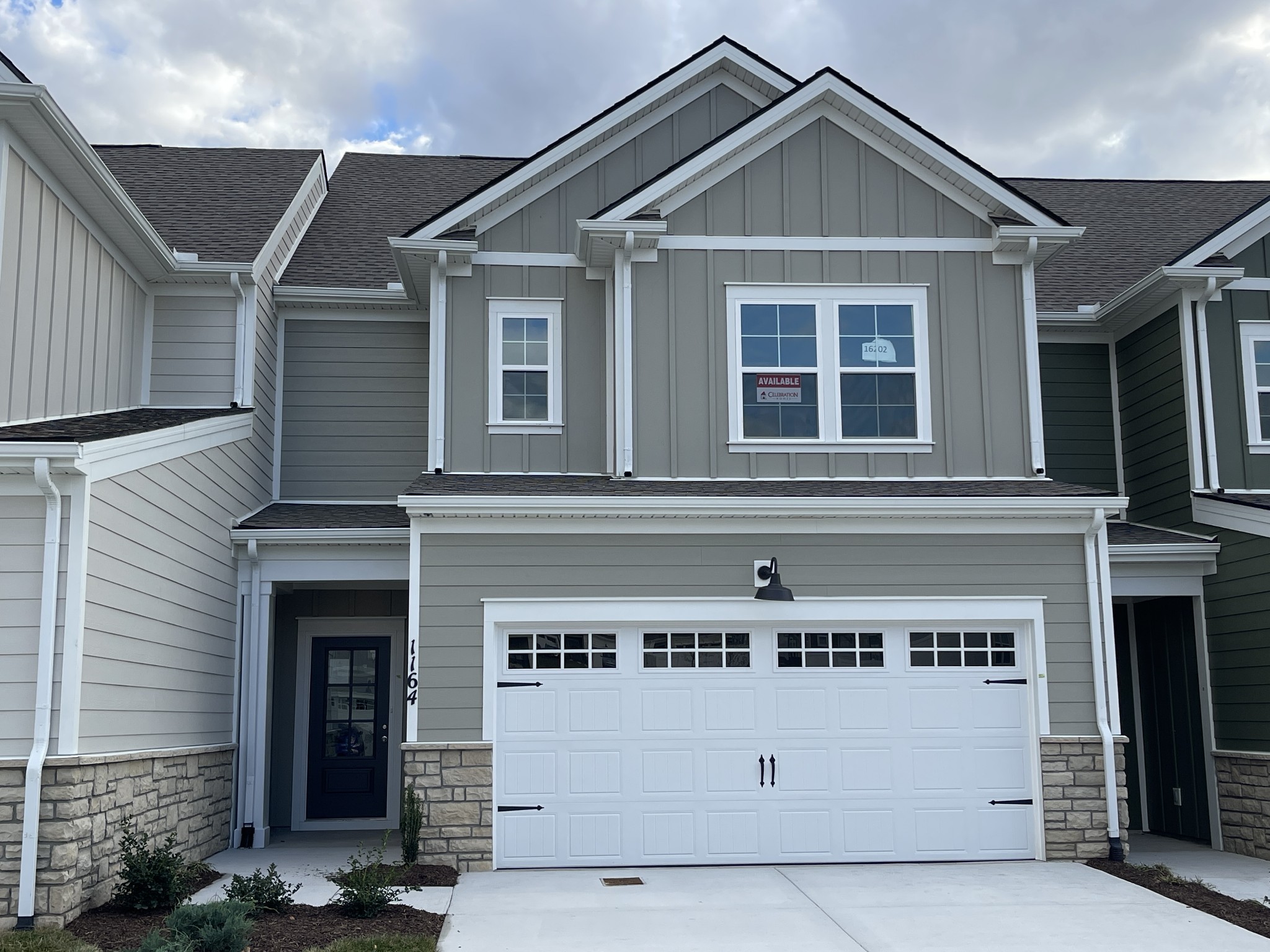 1164 June Wilde Ridge Spring Hill, TN 37174 - Photo 1 of 13 a front view of a house with a garage
