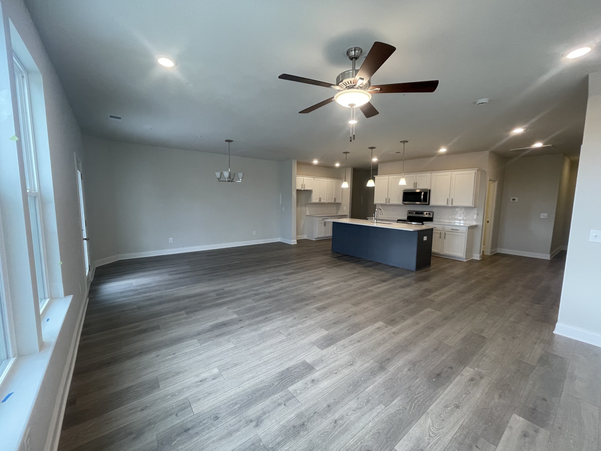 1164 June Wilde Ridge Spring Hill, TN 37174 - Photo 2 of 13 an empty room with wooden floor and a kitchen