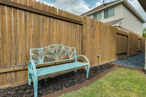 a wooden bench sitting in front of a house
