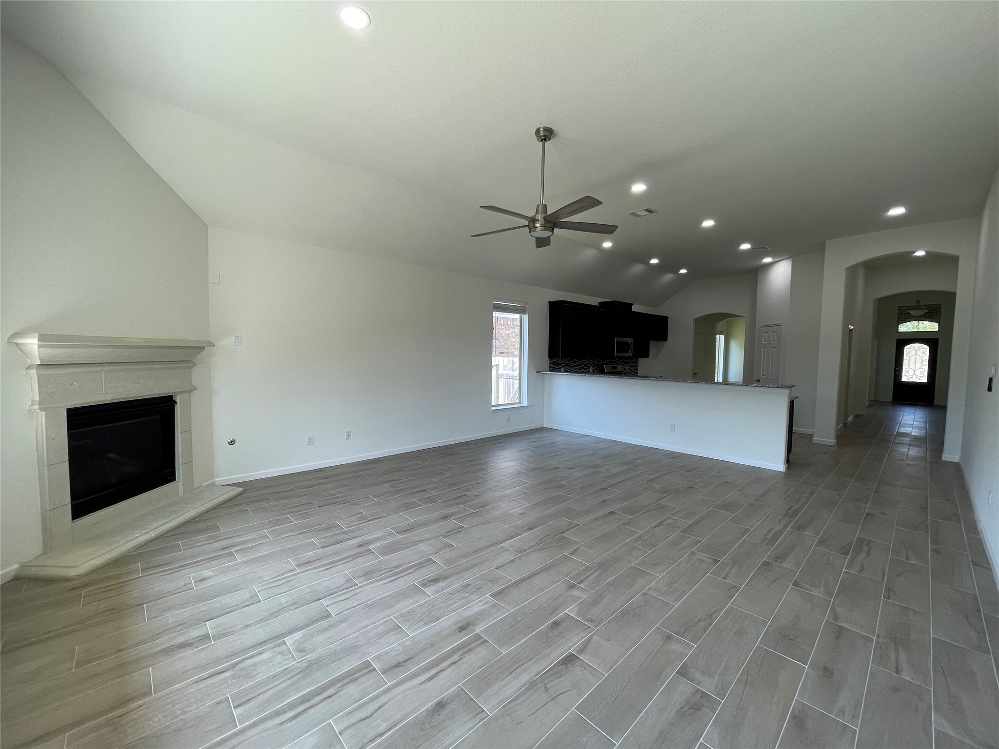 4118 Guild Meadows Drive Houston, TX 77084 - Photo 24 of 35 a view of an empty room with wooden floor and a fireplace