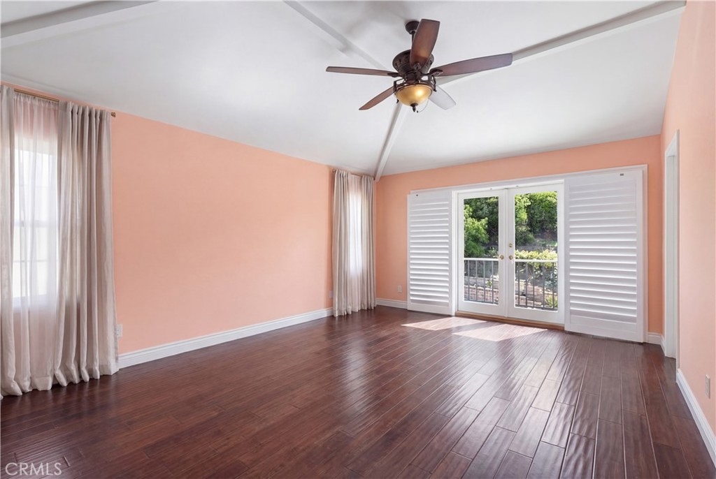 21732 Exton Way Lake Forest, CA 92630 - Photo 12 of 29 Primary bedroom with ceiling fan, ensuite, french doors leading to balcony. Personal items digitally removed. Find originals here https://bit.ly/3OvKmPn