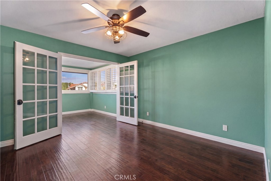 21732 Exton Way Lake Forest, CA 92630 - Photo 16 of 29 Top floor bedroom with bonus office space. Ceiling fan and french doors. Personal items digitally removed, find originals at https://bit.ly/3OvKmPn