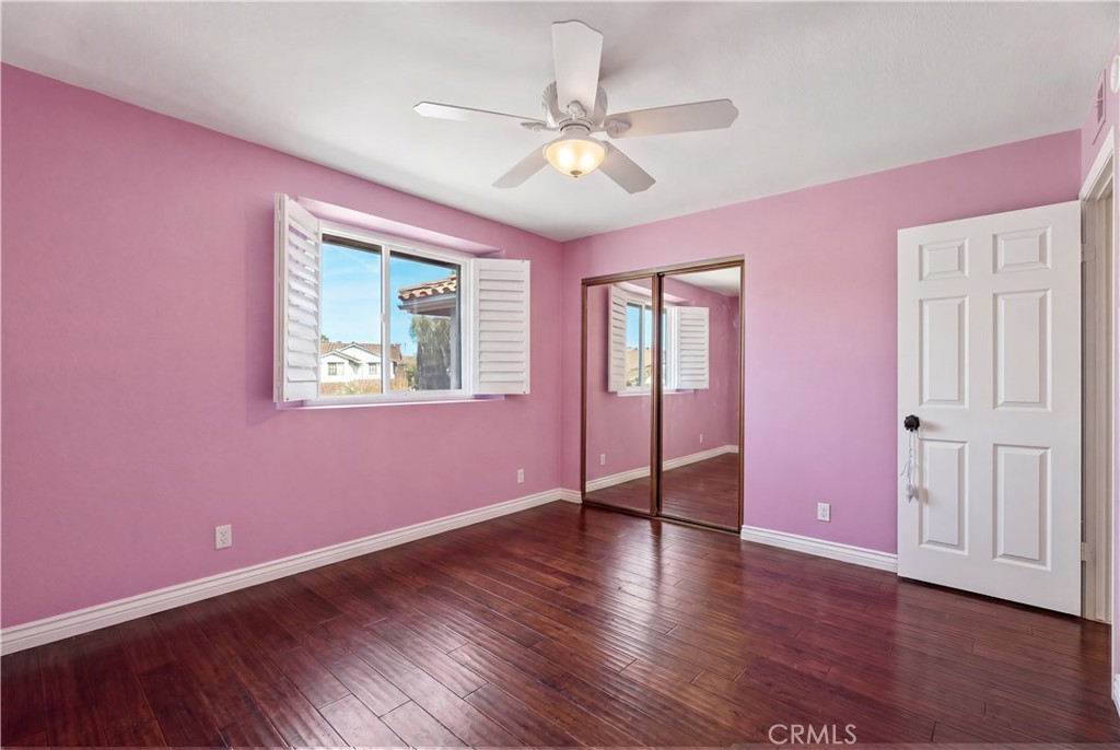 21732 Exton Way Lake Forest, CA 92630 - Photo 18 of 29 Top floor bedrooms with ceiling fan and wooden shutters. Personal items digitally remove, find originals here https://bit.ly/3OvKmPn
