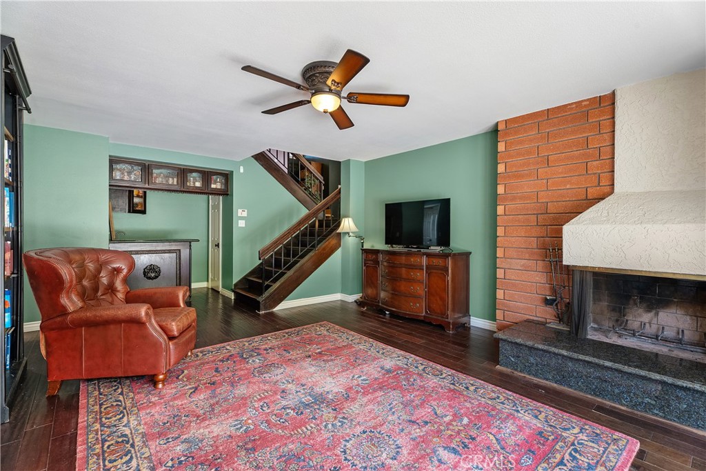 21732 Exton Way Lake Forest, CA 92630 - Photo 20 of 29 Bottom floor bonus room with ceiling fan, fireplace, wet bar, and under stair storage.