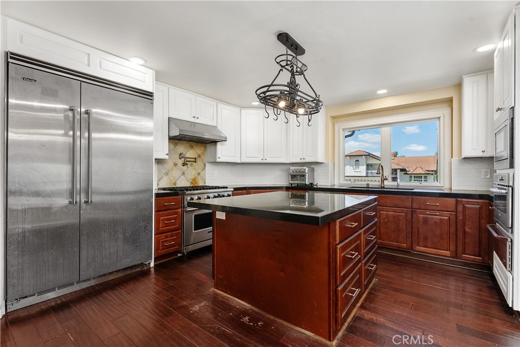 21732 Exton Way Lake Forest, CA 92630 - Photo 6 of 29 Chef Kitchen with built in Viking frides, 6 burner Viking stove, convection oven, double ovens, island with storage and power.