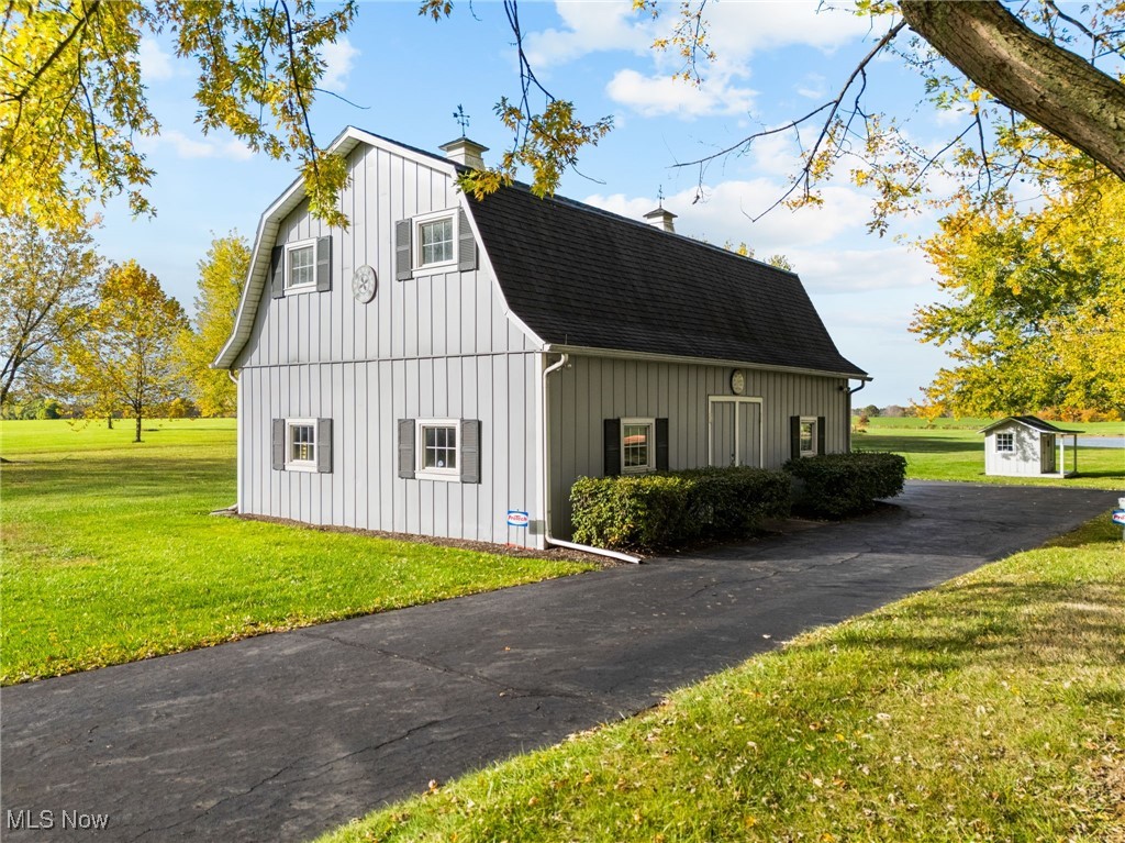 14265 Reeder Avenue Northeast Alliance, OH 44601 - Photo 27 of 39 View of side of property featuring an outdoor structure, a yard, a shingled roof, a gambrel roof, and a barn