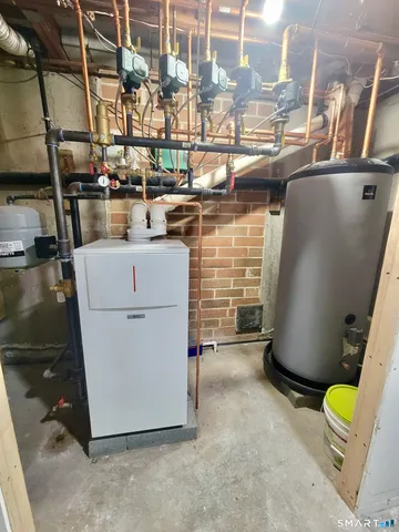 a view of storage and utility room with two washing machine