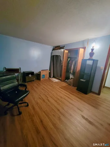 a bedroom with a bed and a mirror