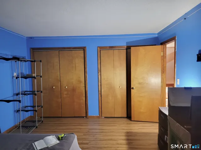a view of hallway with wooden floor