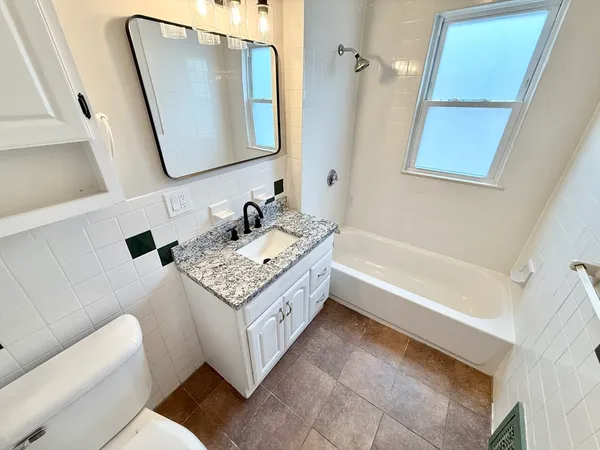 a bathroom with a double vanity sink and a mirror