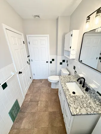 a bathroom with a tub sink and mirror