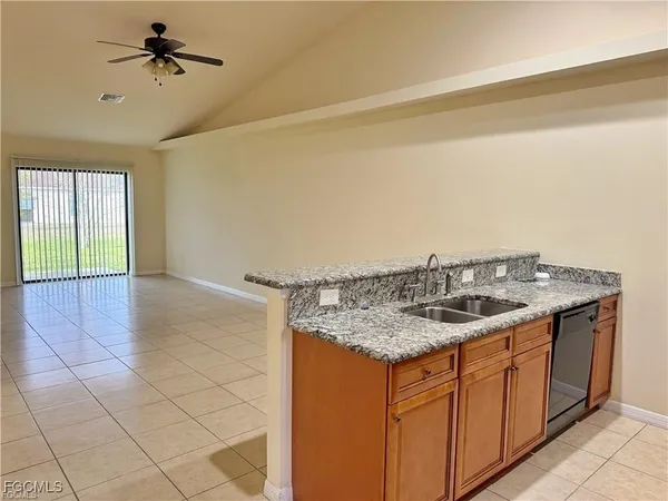 a kitchen with a sink cabinets and wooden floor
