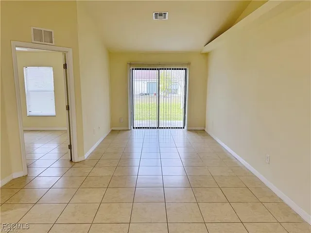 a view of a livingroom with an empty space and a window