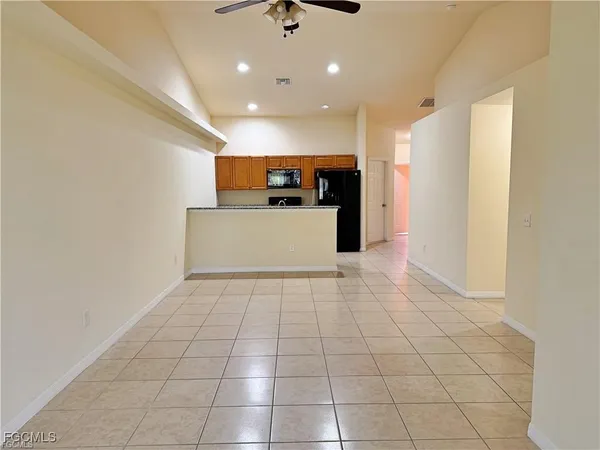 a view of a kitchen with a sink and a refrigerator