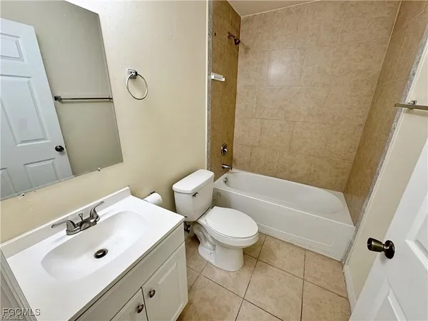 a bathroom with a sink mirror vanity and toilet