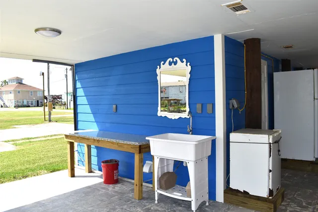a bathroom with a sink toilet and window
