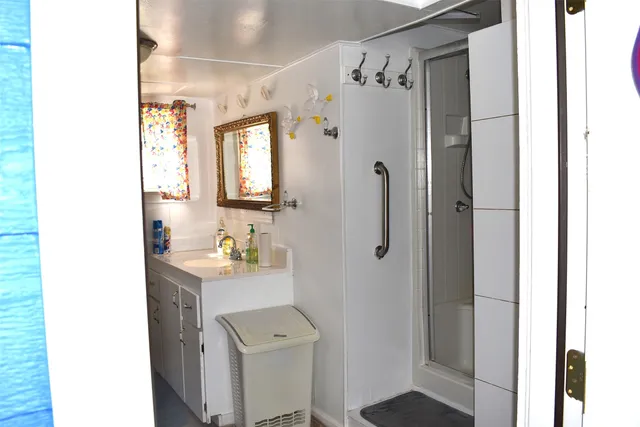 a bathroom with a sink toilet and window
