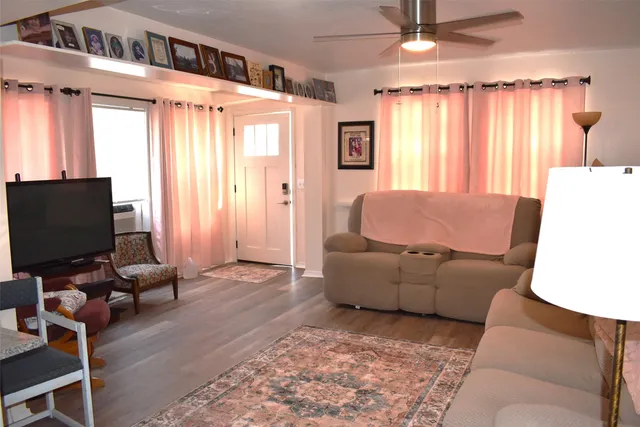 a kitchen with a dining table chairs and refrigerator