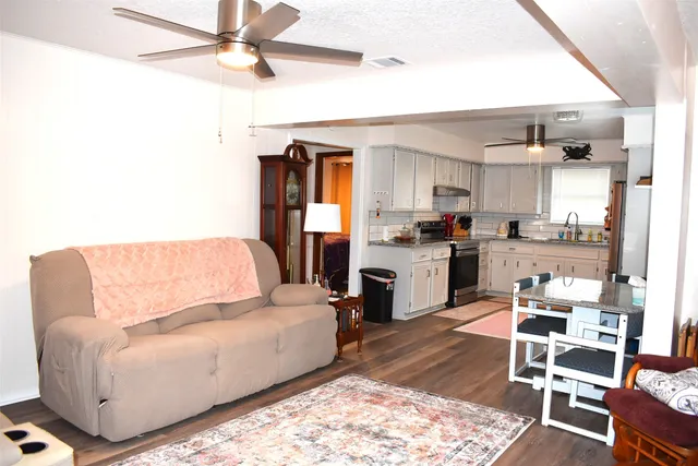 a living room with furniture rug and wooden floor