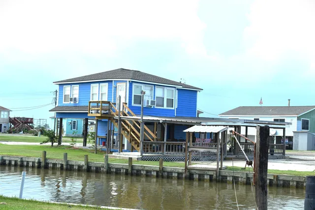 a view of a lake with a big yard and large trees