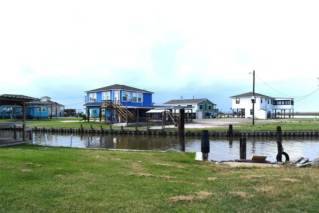 a view of a lake with a house and a yard