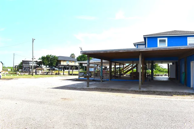 a view of a swimming pool with chairs in patio