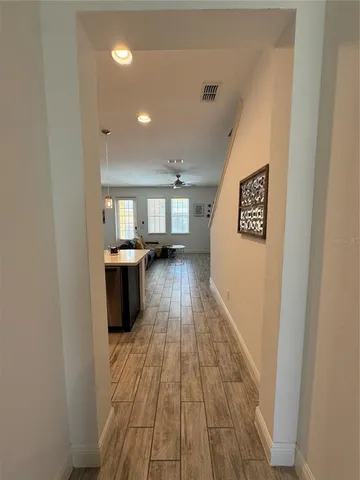 a view of a kitchen with a sink and wooden floor