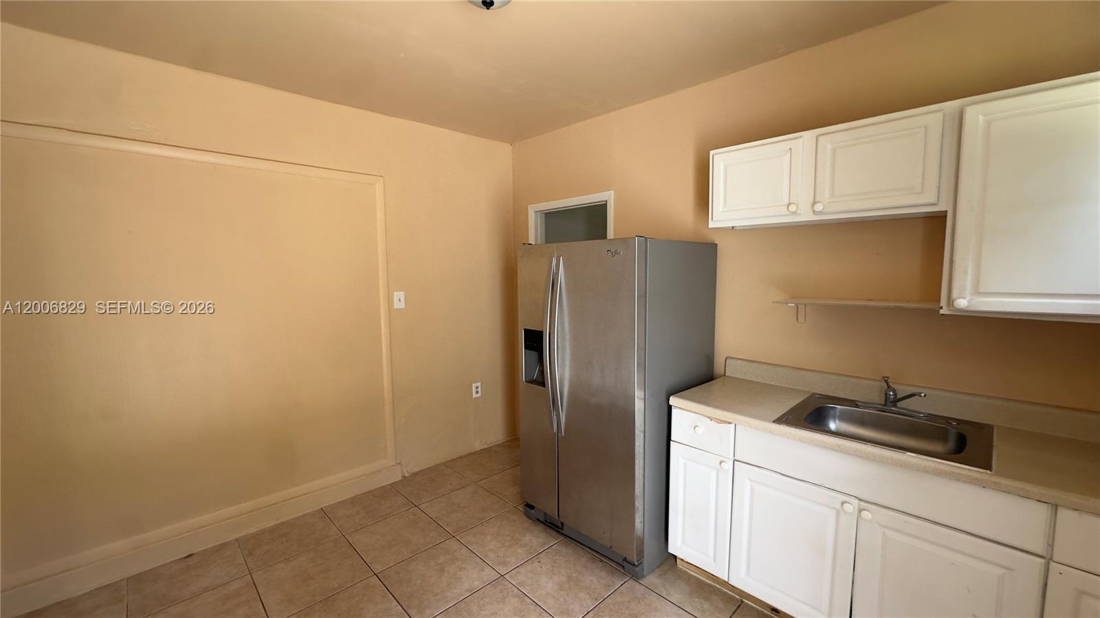 3733 Kirk Road Lake Worth, FL 33461 - Photo 19 of 24 a kitchen with a refrigerator and cabinets